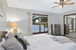 Main level master bedroom with a king size bed and waterfront views of Hutchins Lake 
